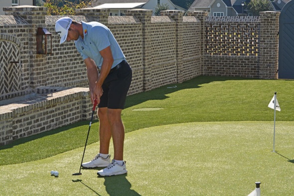 Detroit and all of Michigan Golfer putting on synthetic grass